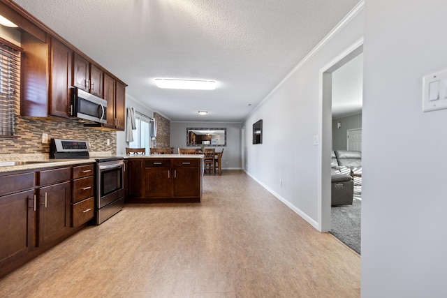 kitchen with appliances with stainless steel finishes, backsplash, kitchen peninsula, ornamental molding, and dark brown cabinets