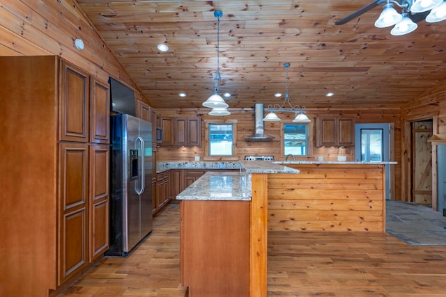 kitchen with pendant lighting, light hardwood / wood-style floors, a healthy amount of sunlight, and stainless steel appliances