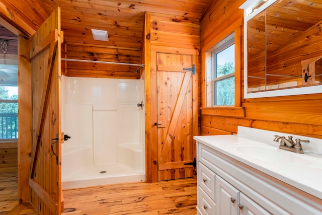 bathroom featuring hardwood / wood-style floors, a shower, plenty of natural light, and wooden ceiling