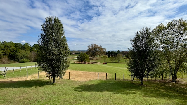 surrounding community with a rural view and a yard