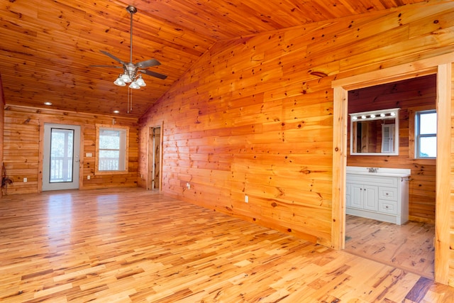 interior space featuring ceiling fan, light hardwood / wood-style flooring, high vaulted ceiling, wood walls, and wood ceiling