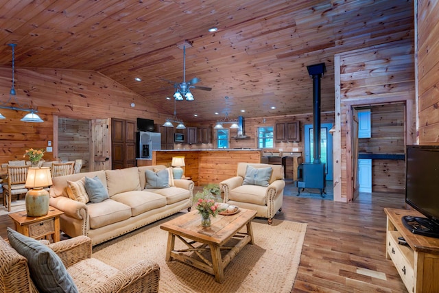 living room featuring high vaulted ceiling, wood walls, light wood-type flooring, and wood ceiling