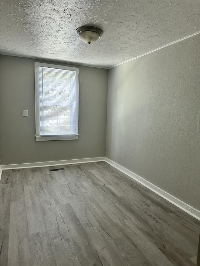 1453 Barnes St NE, Cleveland, TN 37311 - empty room with a textured ceiling and wood finished floors