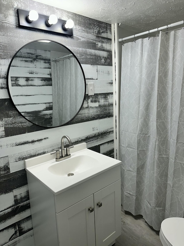 1453 Barnes St NE, Cleveland, TN 37311 - full bathroom with vanity, a textured ceiling, wood finished floors, and a shower with shower curtain