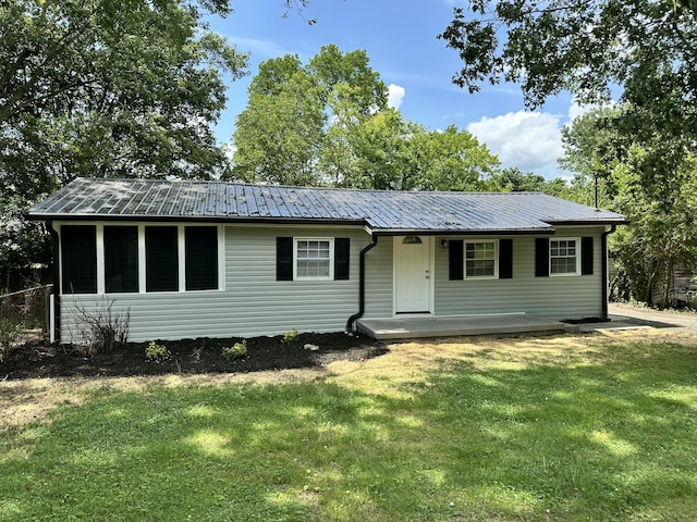 1453 Barnes St NE, Cleveland, TN 37311 - view of front facade with a front yard, covered porch, and a metal roof