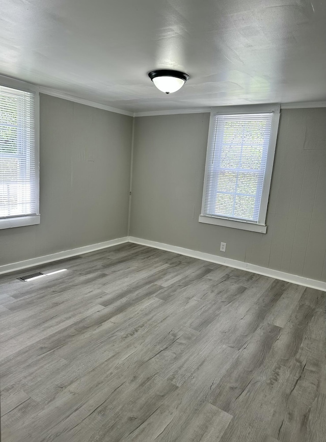 1453 Barnes St NE, Cleveland, TN 37311 - spare room with wood finished floors, healthy amount of natural light, and crown molding