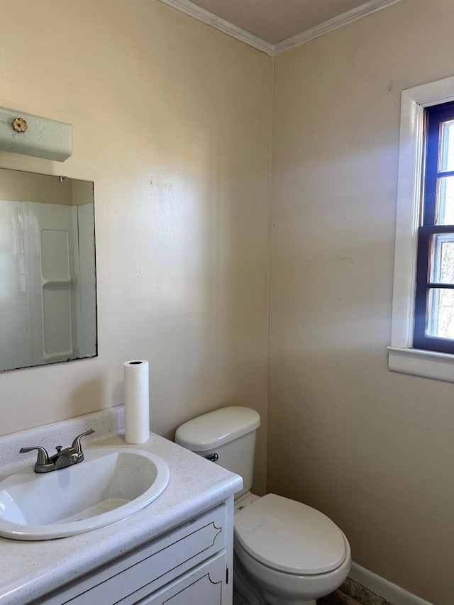 bathroom with vanity, ornamental molding, and toilet