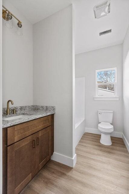 bathroom featuring vanity, toilet, and wood-type flooring