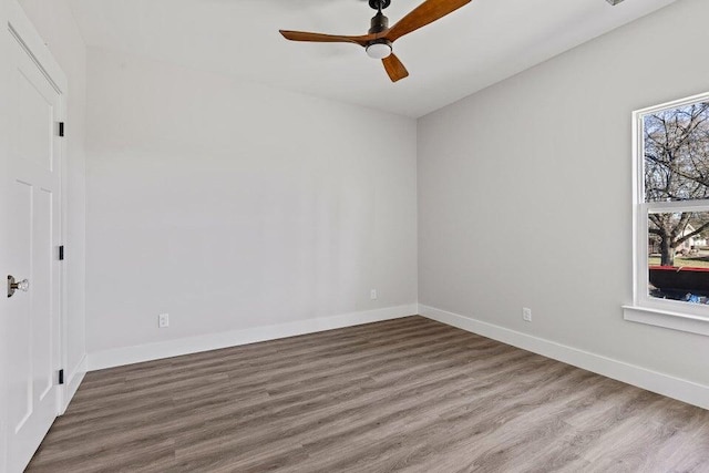 spare room featuring hardwood / wood-style flooring and ceiling fan