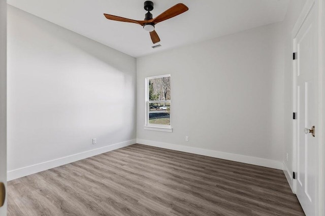 unfurnished room with hardwood / wood-style flooring and ceiling fan