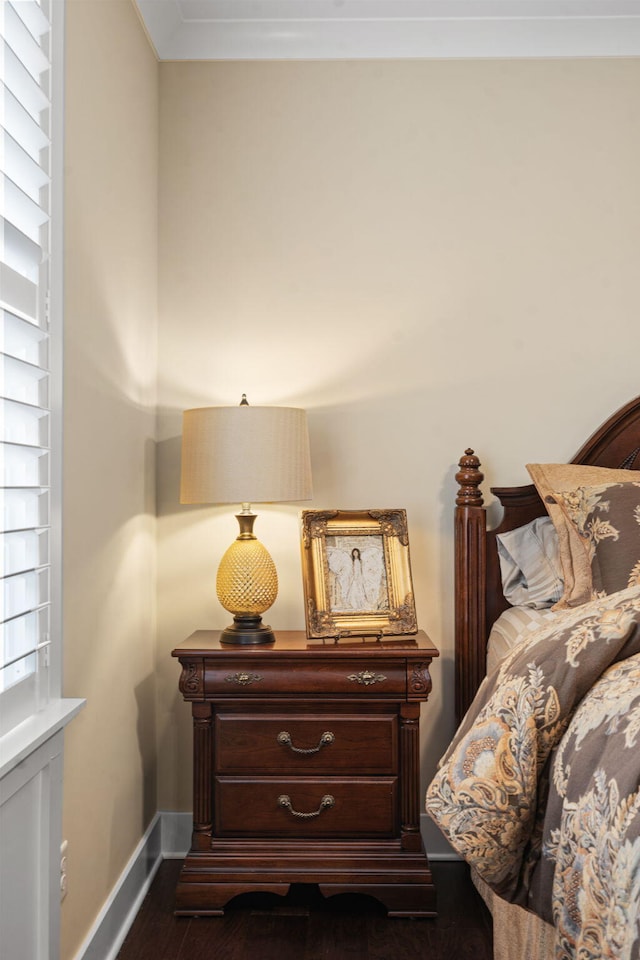 bedroom featuring dark wood-type flooring and ornamental molding