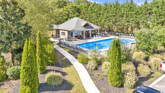 view of swimming pool featuring a patio and an outbuilding