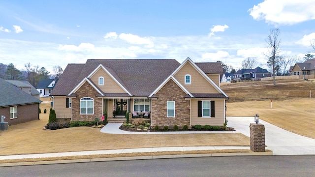 craftsman house with a porch and cooling unit