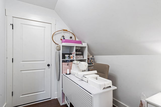 home office featuring vaulted ceiling and dark wood-type flooring