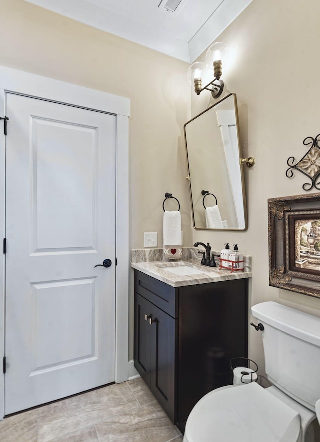 bathroom featuring vanity and toilet