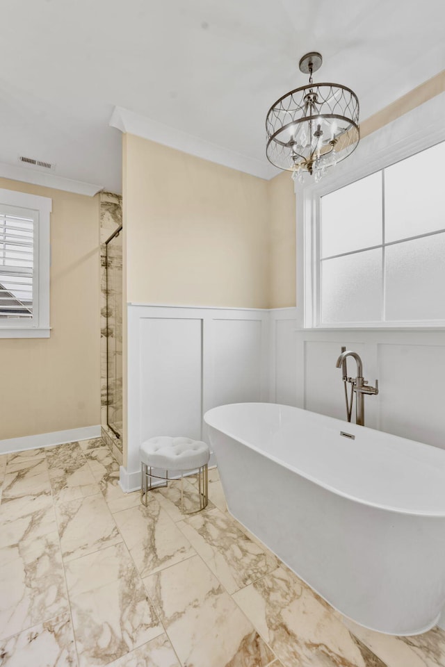 bathroom with crown molding, independent shower and bath, and a chandelier