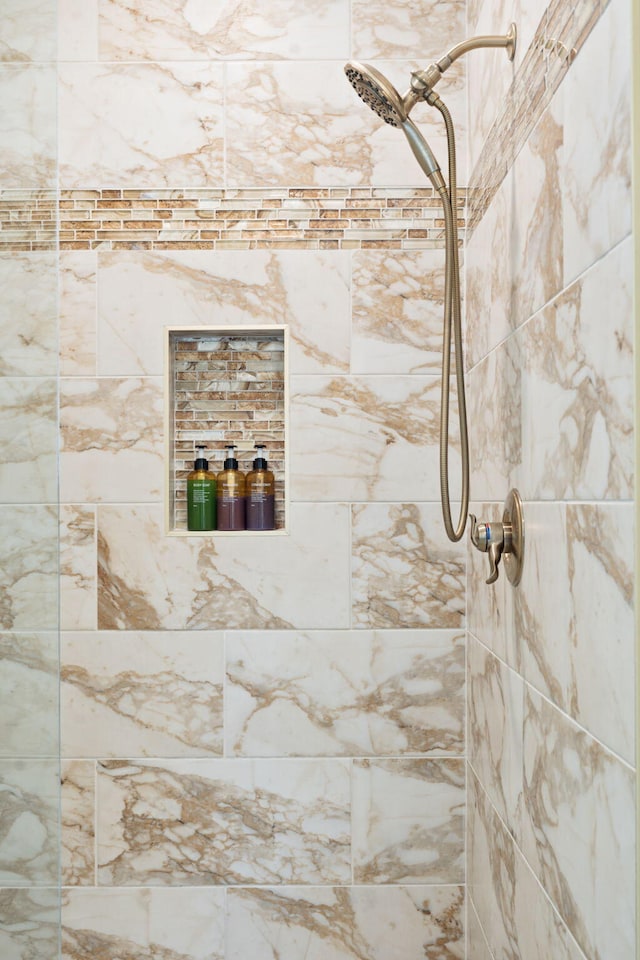 bathroom with a tile shower