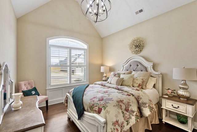 bedroom featuring vaulted ceiling, dark wood-type flooring, and a notable chandelier