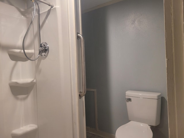 bathroom featuring toilet and a shower