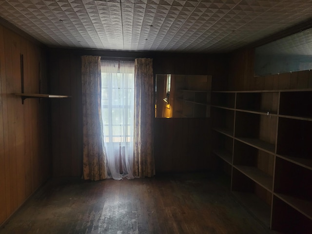 spare room featuring hardwood / wood-style floors and wooden walls