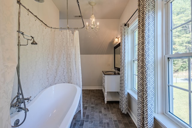 bathroom with vanity, a notable chandelier, and plus walk in shower