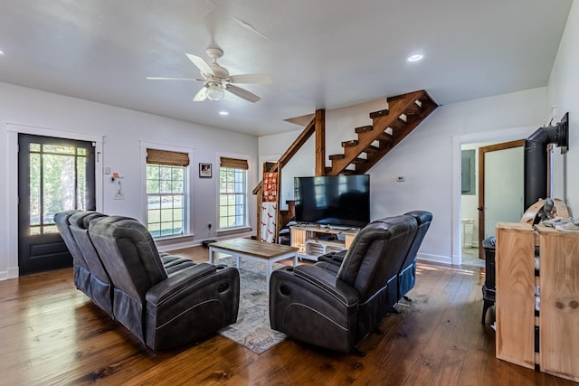 living room with dark hardwood / wood-style floors and ceiling fan