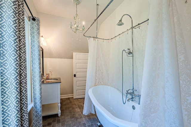 bathroom featuring vanity, a notable chandelier, and shower / bath combo with shower curtain