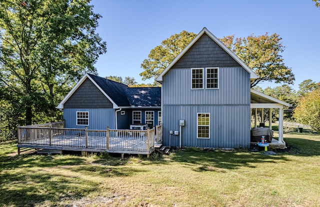 back of house with a wooden deck and a lawn