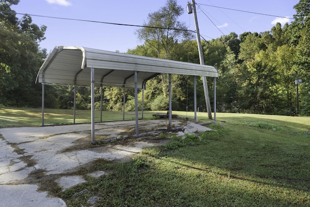 view of parking featuring a yard and a carport