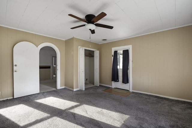 unfurnished bedroom with carpet flooring, ceiling fan, and crown molding