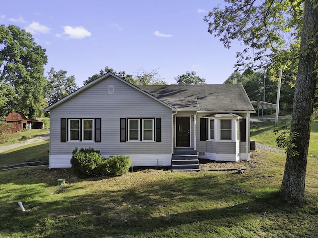 view of front of house with a front lawn and a carport