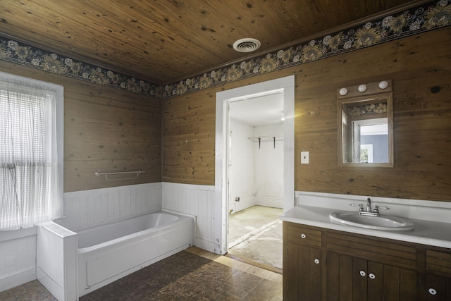 bathroom featuring a bathtub, a healthy amount of sunlight, wooden ceiling, and wooden walls