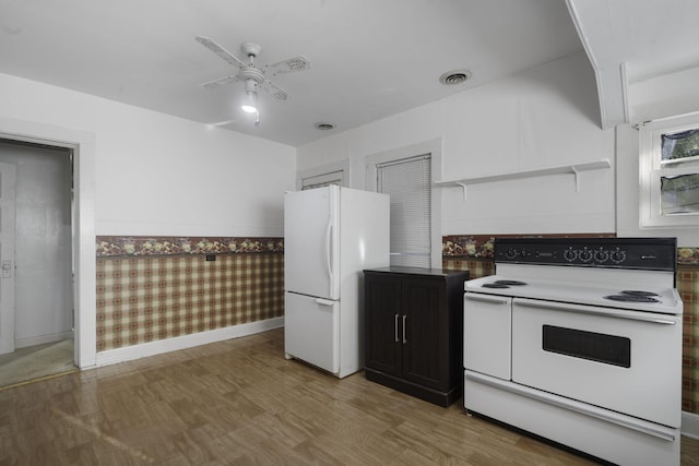 kitchen featuring ceiling fan, white appliances, and hardwood / wood-style flooring