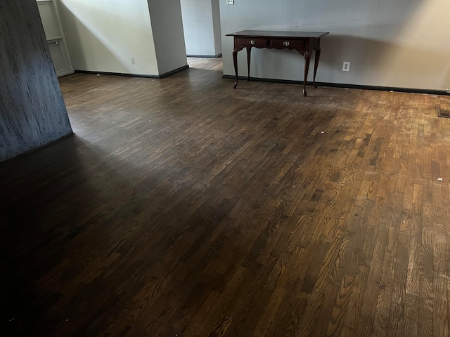 spare room featuring dark hardwood / wood-style floors