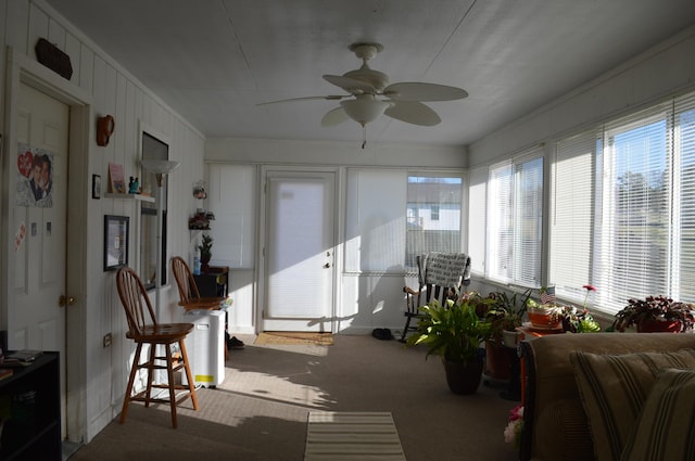 sunroom / solarium featuring ceiling fan