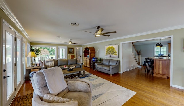 4809 Wind Bluff Cir, Birchwood, TN 37308 - living area with visible vents, light wood-style flooring, stairs, and crown molding