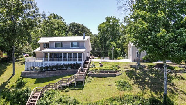 4809 Wind Bluff Cir, Birchwood, TN 37308 - rear view of house with stairway, a lawn, a garage, and a sunroom