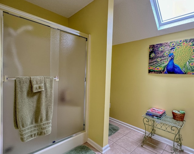 4809 Wind Bluff Cir, Birchwood, TN 37308 - bathroom featuring tile patterned flooring, a shower stall, a skylight, and baseboards