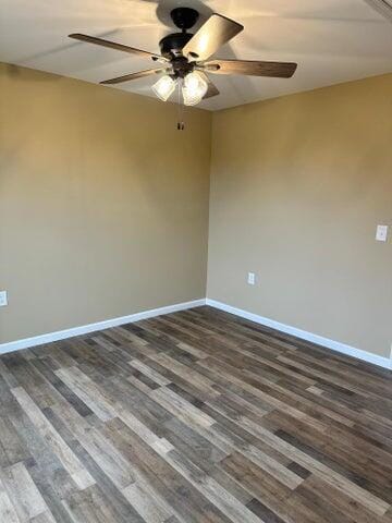 unfurnished room featuring ceiling fan and dark hardwood / wood-style flooring