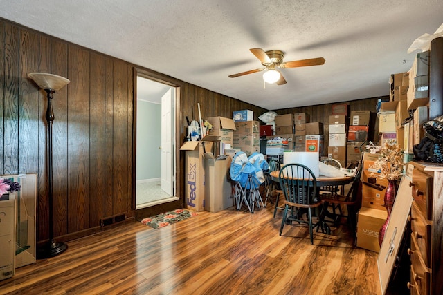 141 Church St, Calhoun, TN 37309 - dining space with wooden walls, wood finished floors, a ceiling fan, and a textured ceiling