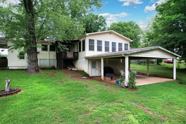141 Church St, Calhoun, TN 37309 - back of house with a yard, a patio area, and a carport