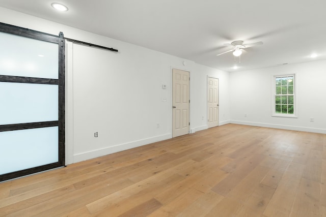 6416 Spring Place Rd SE, Cleveland, TN 37323 - unfurnished room featuring light wood-style flooring, a barn door, ceiling fan, baseboards, and recessed lighting