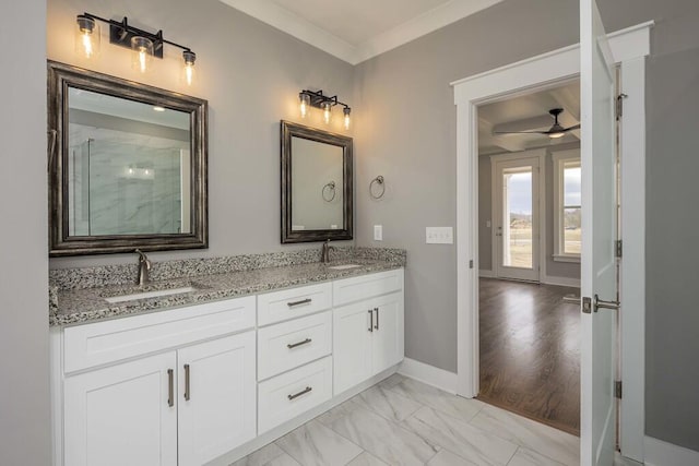 bathroom with ceiling fan, ornamental molding, and vanity