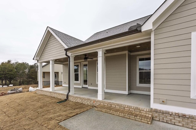 rear view of house featuring ceiling fan and a patio