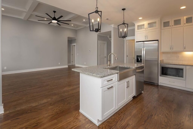 kitchen with sink, white cabinetry, a center island with sink, stainless steel appliances, and light stone countertops