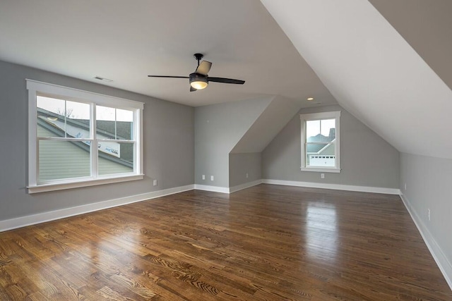 additional living space with dark wood-type flooring, ceiling fan, and vaulted ceiling