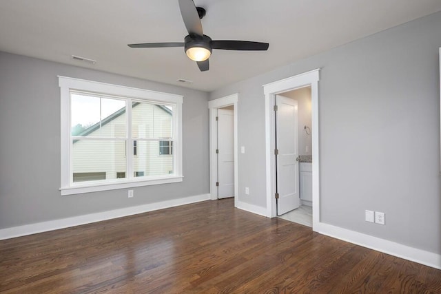 unfurnished bedroom featuring connected bathroom, hardwood / wood-style floors, and ceiling fan