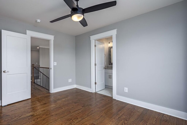 unfurnished bedroom with dark hardwood / wood-style flooring, connected bathroom, and ceiling fan