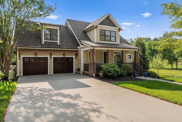 925 Wildcat Run Dr, Loudon, TN 37774 - view of front facade featuring a porch, concrete driveway, a standing seam roof, roof with shingles, and a front yard