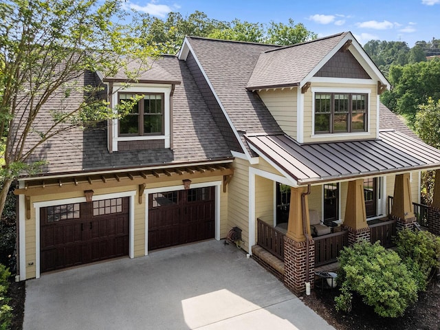 925 Wildcat Run Dr, Loudon, TN 37774 - view of front facade with covered porch, a standing seam roof, concrete driveway, an attached garage, and roof with shingles